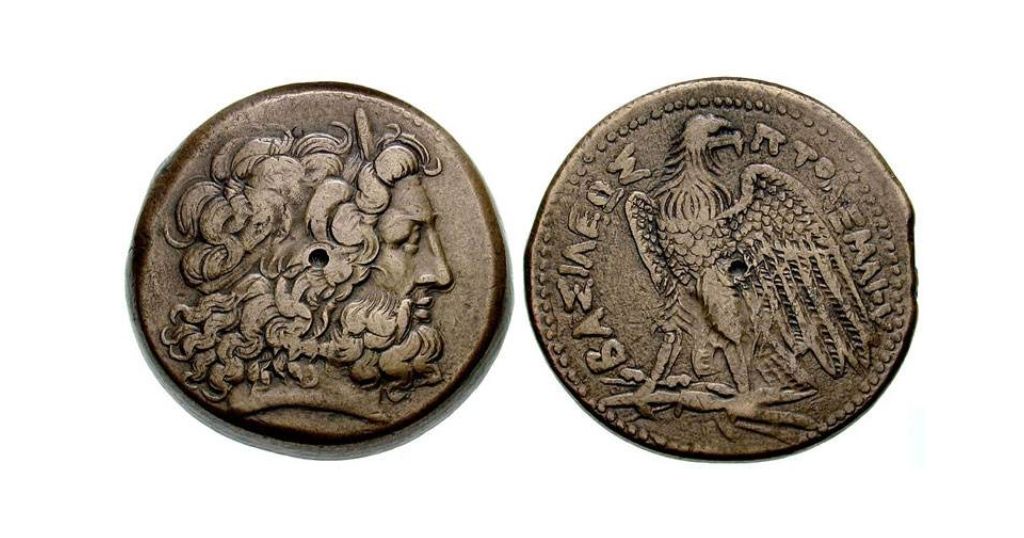 Ptolemaic bronze obol coin that is 1 inch long