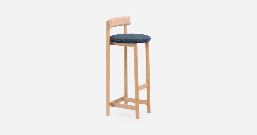 The seat of a bar stool that is 30 inches tall