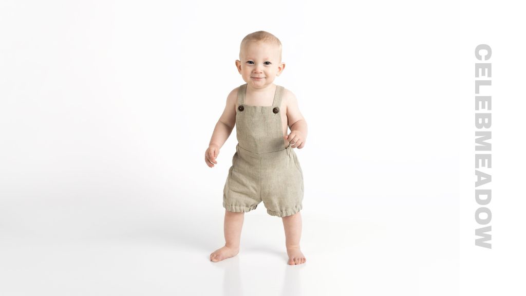 Toddler approximately 36 inches tall standing next to an adult for height comparison
