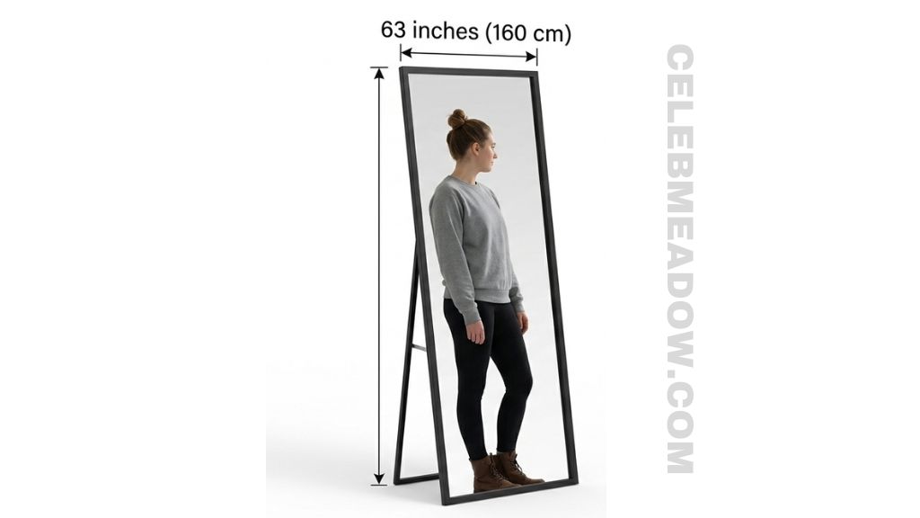 Floor-standing full-length mirror approximately 63 inches tall showing reflection of person from head to mid-calf